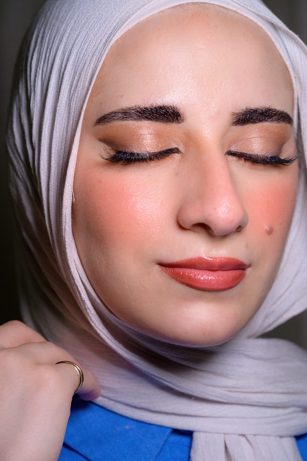 Bold makeup with winged eyeliner and warm lip tones